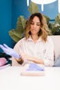 Young woman in a beauty salon putting on latex gloves, ready to work.